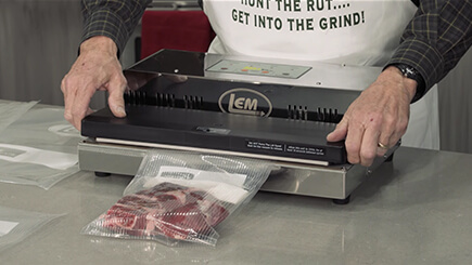 Meat being vacuum sealed inside of an LEM MaxVac 1000