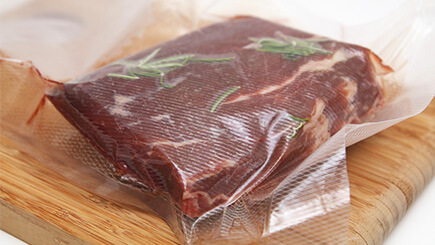Vacuum sealed meat on a cutting board