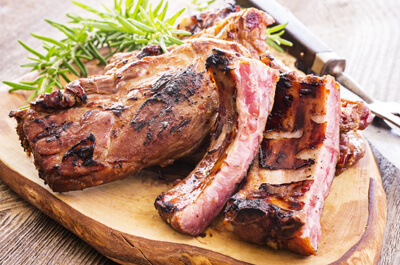 Large cooked ribs on a serving plate