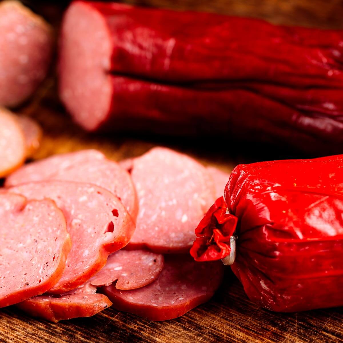 Served summer sausage on a cutting board